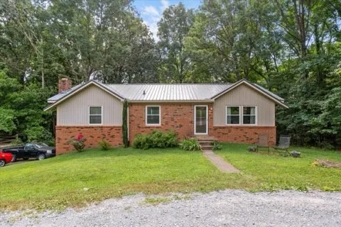 a view of a house and a yard with green space