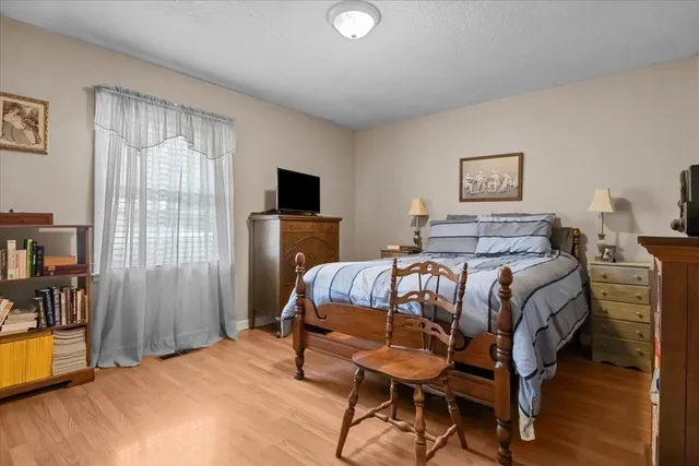 a bedroom with furniture and a flat screen tv