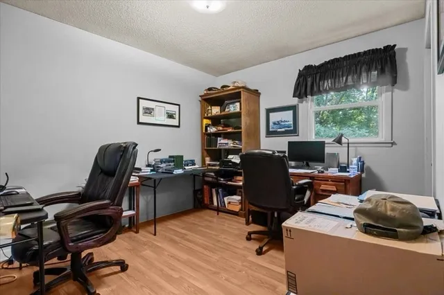 a view of a workspace with furniture and a window