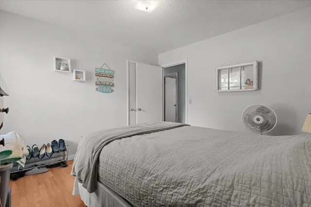 a living room with furniture a flat screen tv and a book shelf