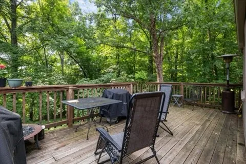 a view of a deck with furniture and wooden deck