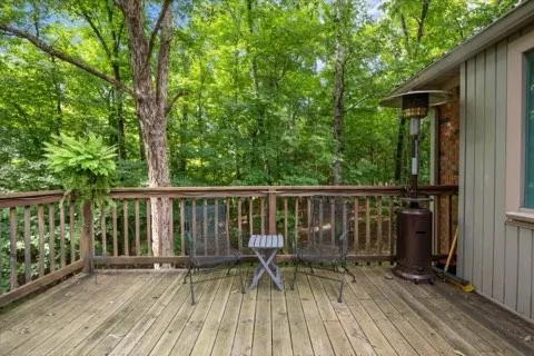 a view of balcony with chairs and wooden fence