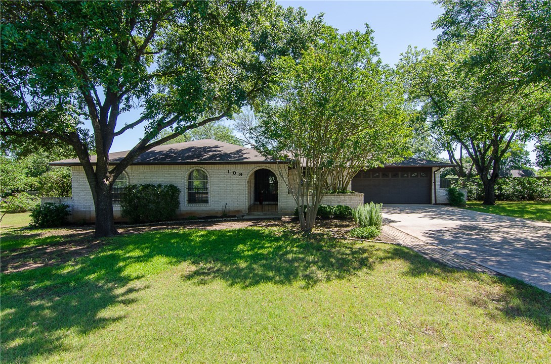 109 Woodland Road Georgetown, TX 78628 - Photo 1 of 1 a front view of a house with garden