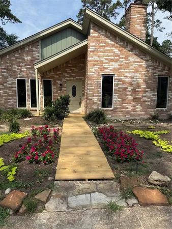a front view of house with flowers