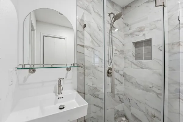 a bathroom with a sink and a shower