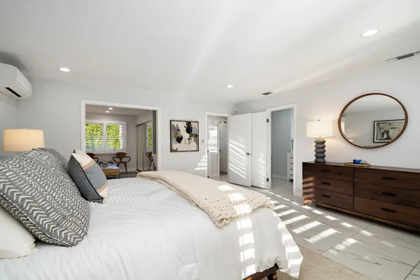 a bedroom with furniture and a window