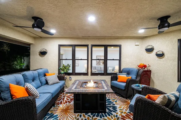 a view of a house with backyard and furniture