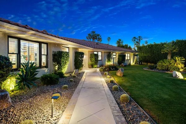 a view of front door and potted plants