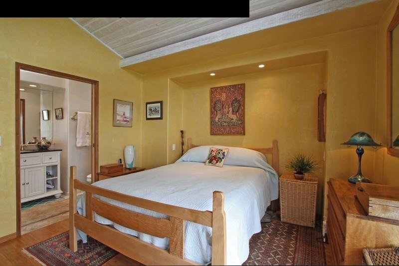 967 Polipoli Road Kula, HI 96790 - Photo 8 of 11 a bedroom with a bed and wooden floor