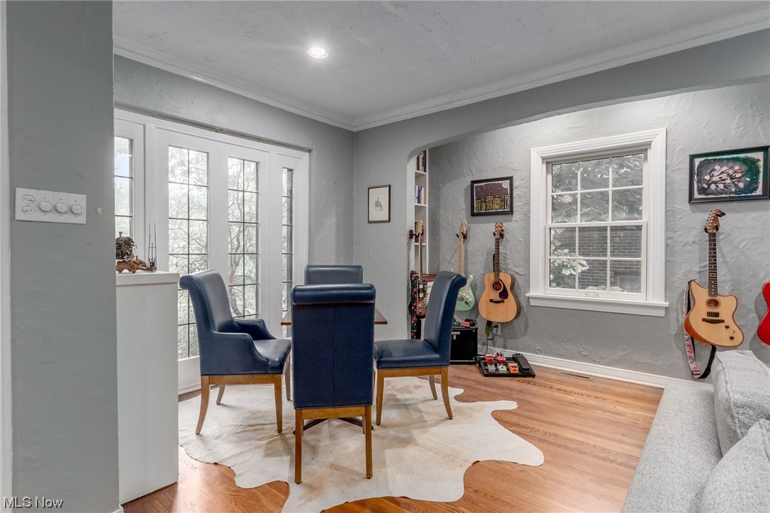Dining room featuring hardwood flooring and ornamental molding