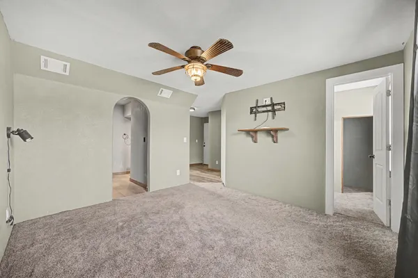 a view of a big room with closet and a chandelier fan