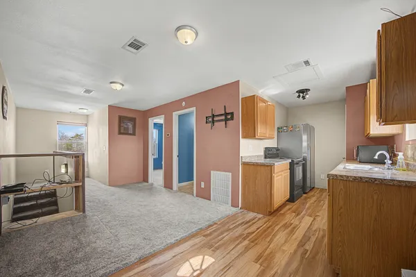 a kitchen with stainless steel appliances granite countertop a refrigerator and stove top oven