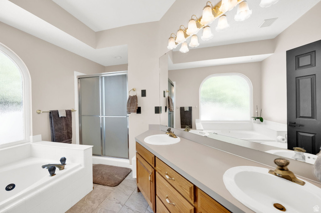 5057 South Ridgedale Drive Ogden, UT 84403 - Photo 19 of 69 Bathroom featuring a dual vanity with oak cabinetry, a large mirror, and a multi-bulb light fixture