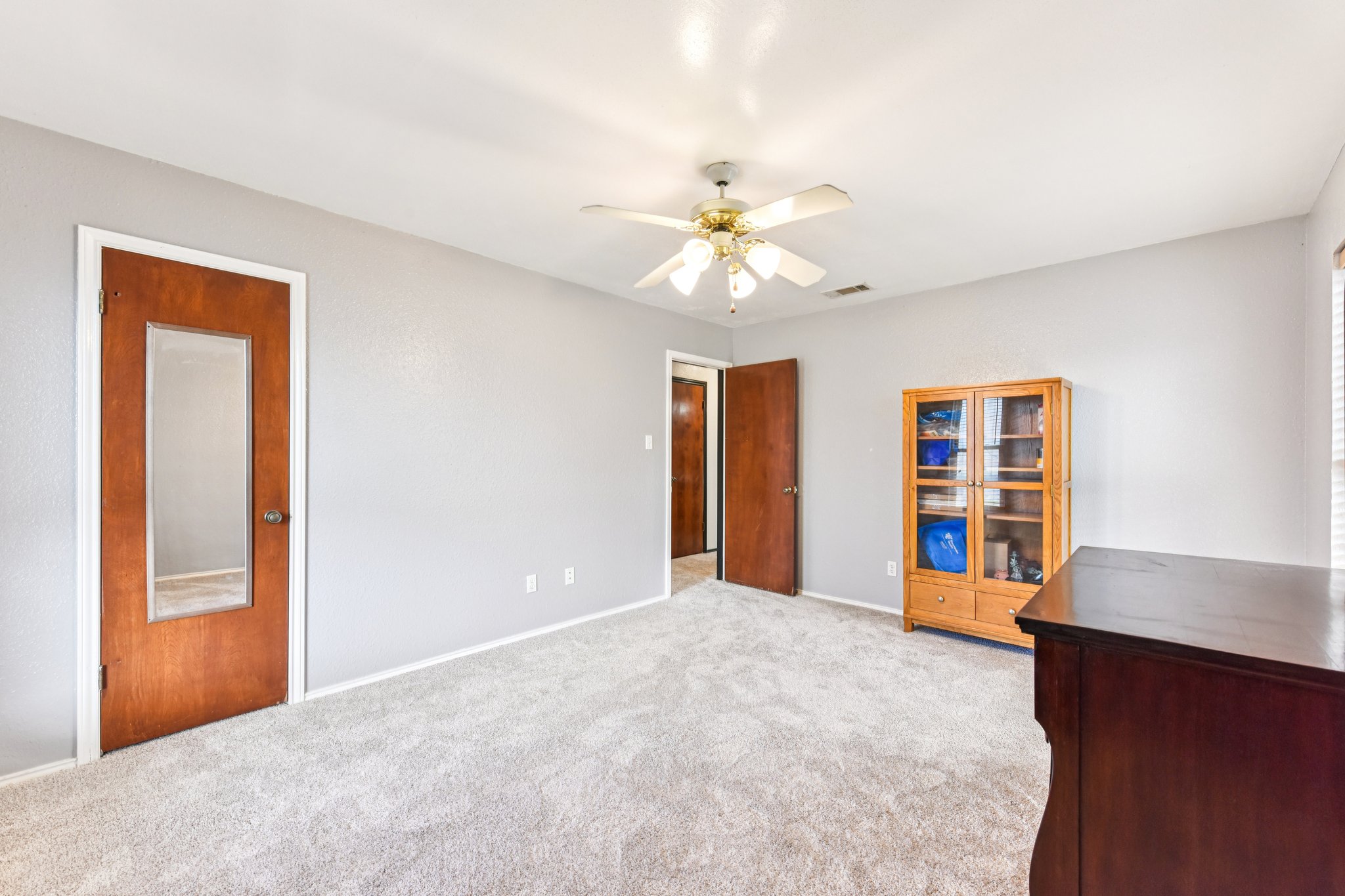 504 Buckaroo Trail Buda, TX 78610 - Photo 10 of 39 Unfurnished bedroom featuring light colored carpet and a ceiling fan