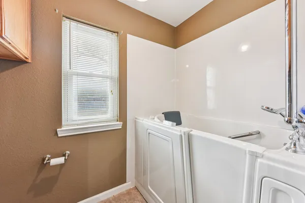 a bathroom with a double vanity sink toilet and mirror