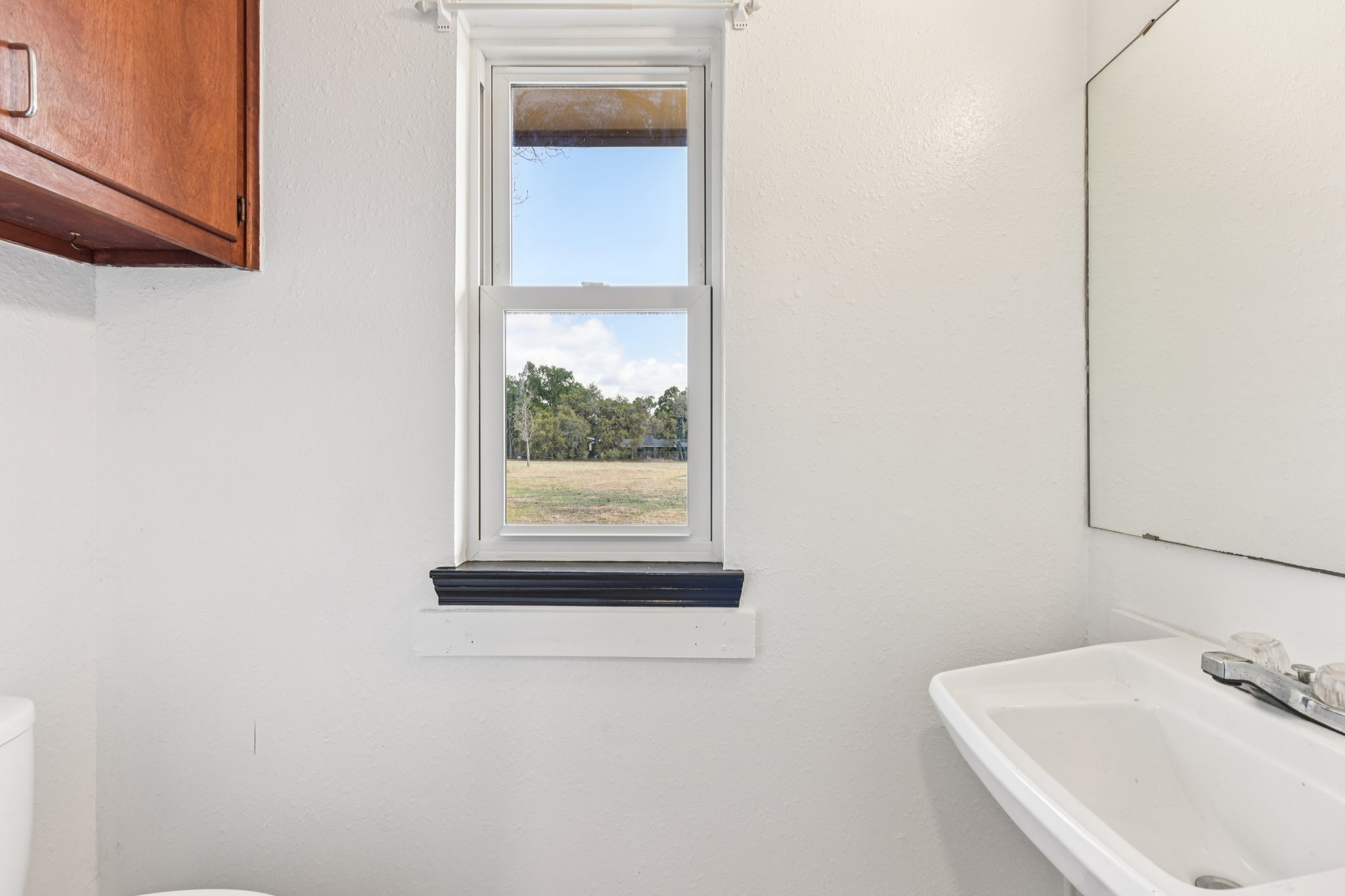 504 Buckaroo Trail Buda, TX 78610 - Photo 21 of 39 Half bath off laundry, with a sink and toilet used as Pool Bath