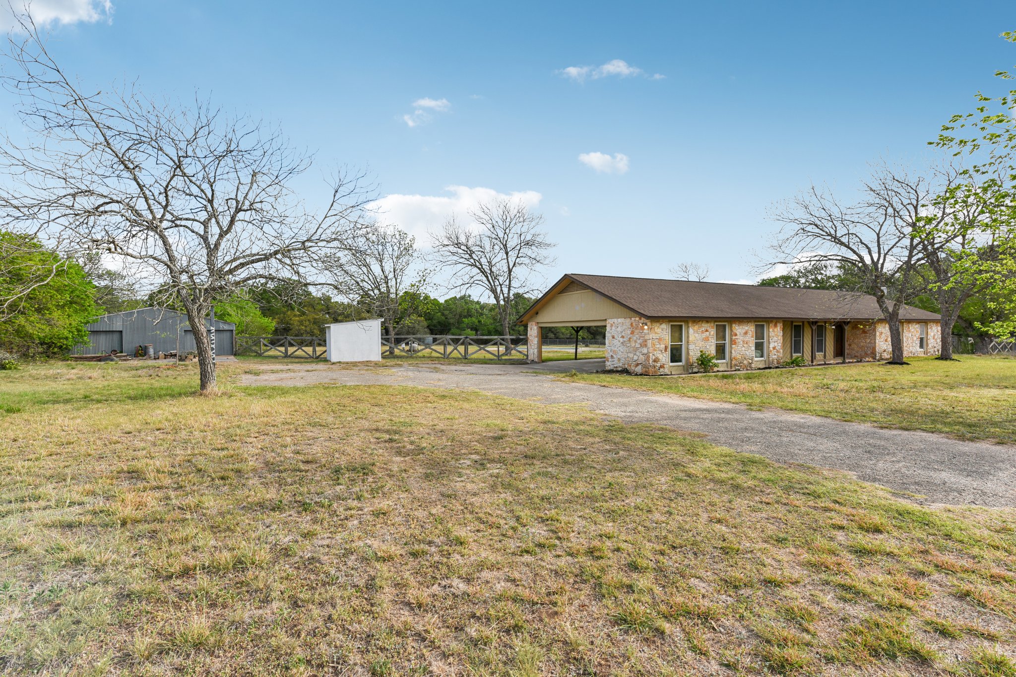 504 Buckaroo Trail Buda, TX 78610 - Photo 3 of 39 Single story home with a front lawn, driveway, and stone siding