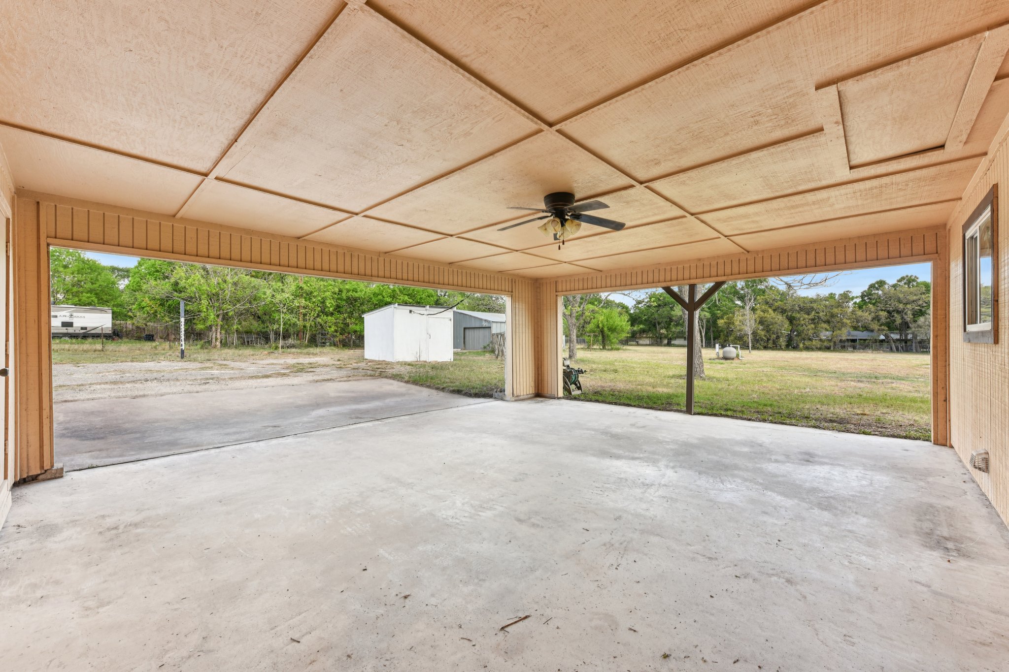 504 Buckaroo Trail Buda, TX 78610 - Photo 4 of 39 View of Carport/Patio featuring a storage shed