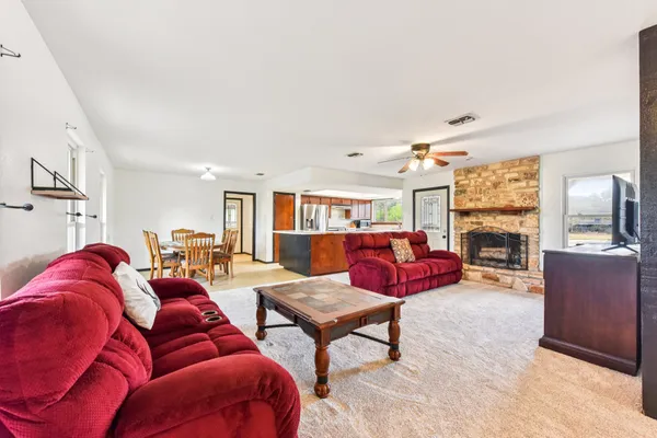 a living room with furniture dining table and a chandelier