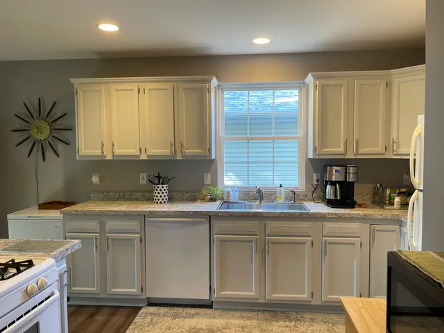 a kitchen with a sink stove and cabinets
