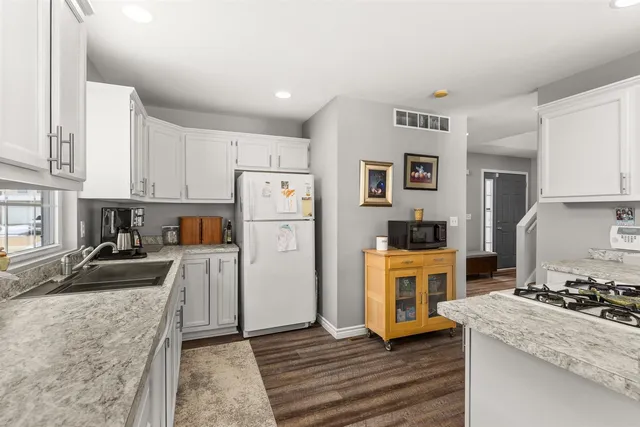 a kitchen with a stove a refrigerator and a sink
