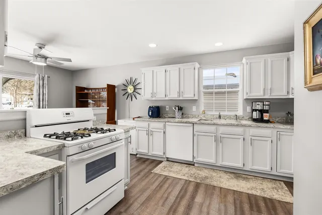a kitchen with stainless steel appliances white cabinets and a stove