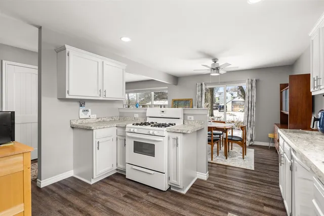 a kitchen with a sink stove and cabinets