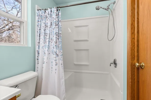 a bathroom with a shower and a toilet