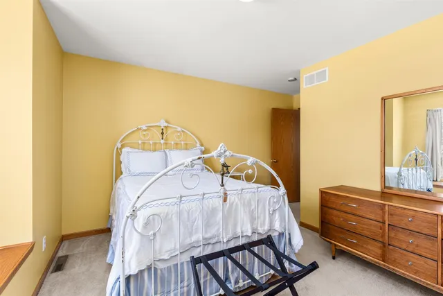 a view of a bedroom with wooden floor