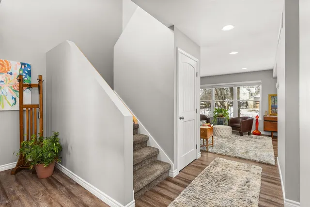 a living room with furniture floor to ceiling window and wooden floor