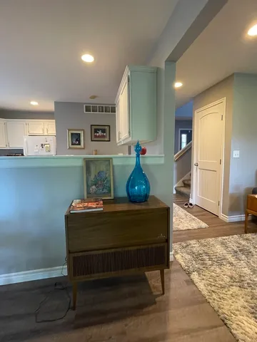 a view of hall way with furniture and window