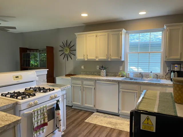 a kitchen with a stove a sink and a cabinets