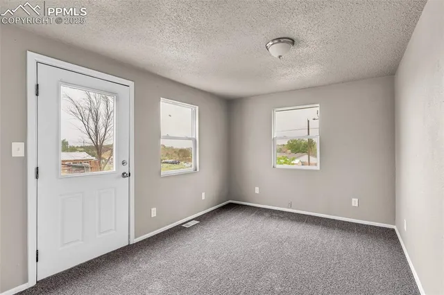 a view of an empty room with a window