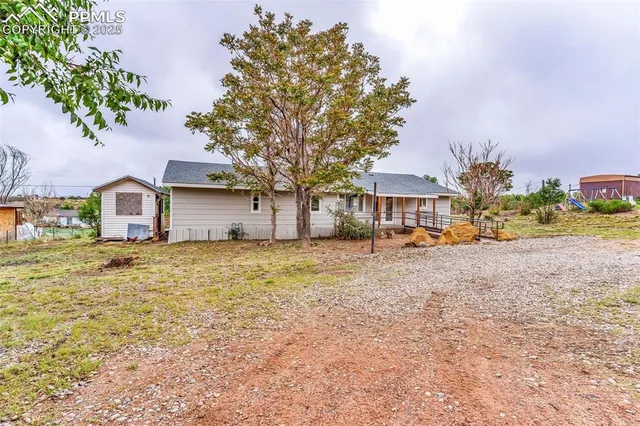 a view of a house with a yard and sitting area