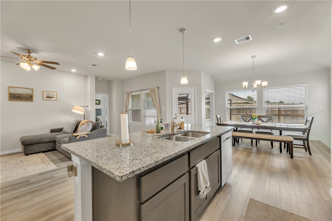 2016 Chief Street Bryan, TX 77807 - Photo 16 of 30 an open kitchen with granite countertop kitchen island stainless steel appliances sink dining table and chairs