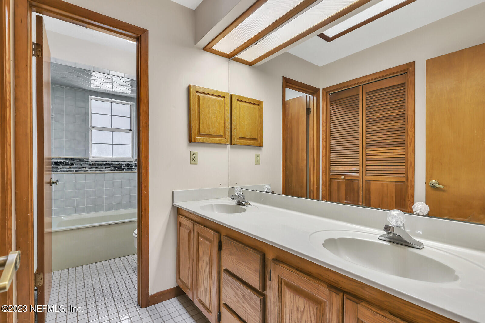 4250 Banks Road Middleburg, FL 32068 - Photo 16 of 48 a bathroom with a double vanity sink and a mirror