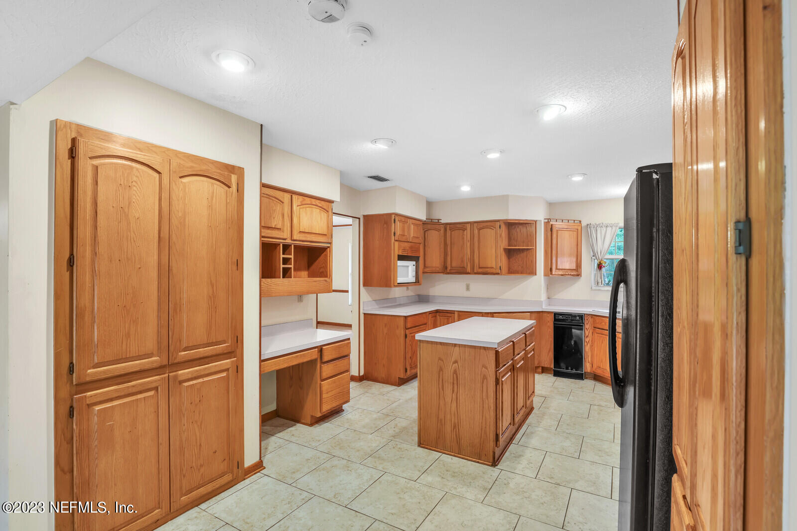 4250 Banks Road Middleburg, FL 32068 - Photo 28 of 48 a kitchen with a refrigerator and microwave