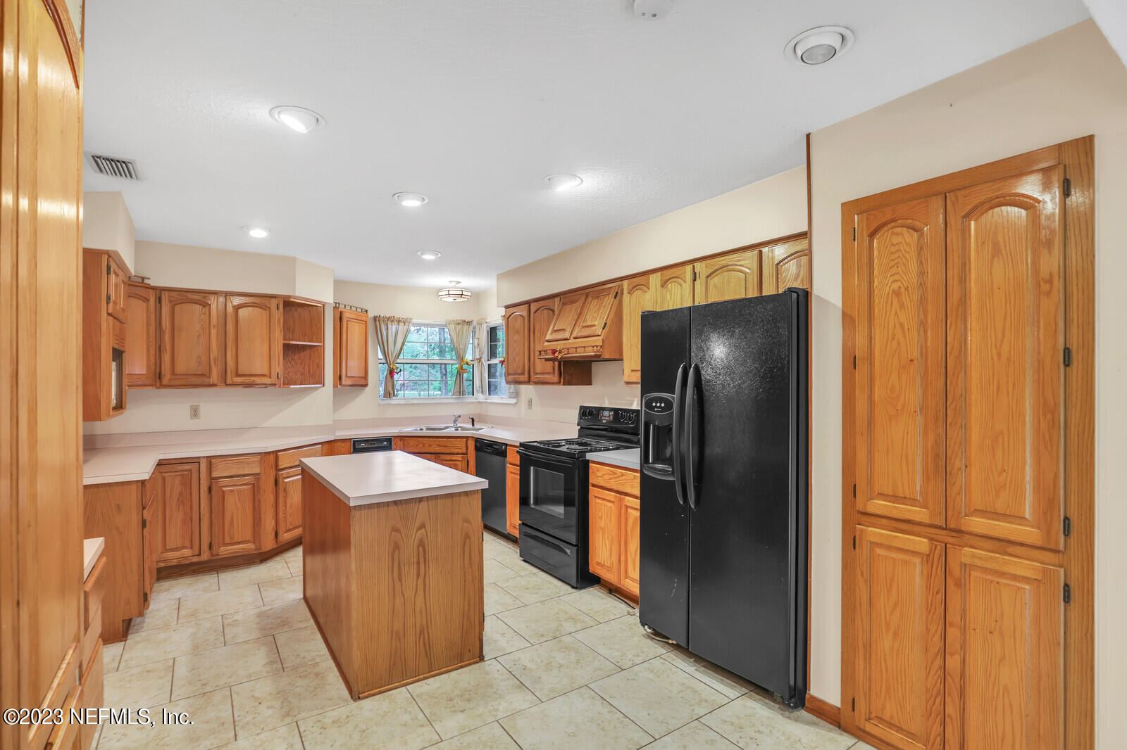 4250 Banks Road Middleburg, FL 32068 - Photo 29 of 48 a kitchen with stainless steel appliances granite countertop a refrigerator and a sink