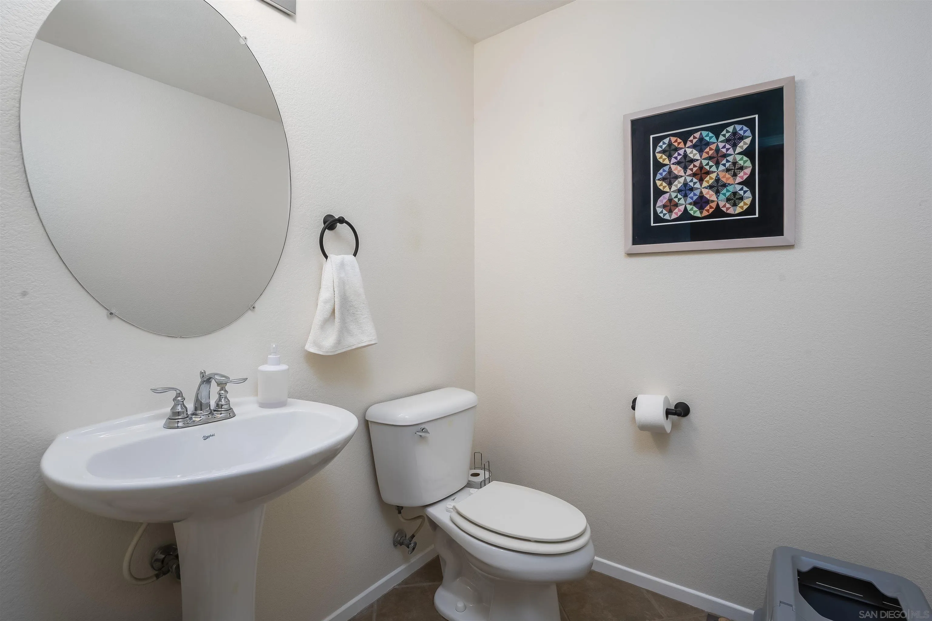 289 Reef Point Way, Unit 3 Oceanside, CA 92058 - Photo 17 of 23 a bathroom with a toilet sink and mirror