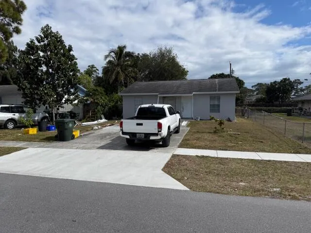 a view of a street with cars parked