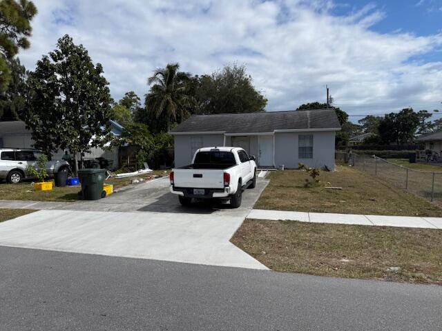448 Perry Avenue Greenacres, FL 33463 - Photo 3 of 14 a view of a street with cars parked