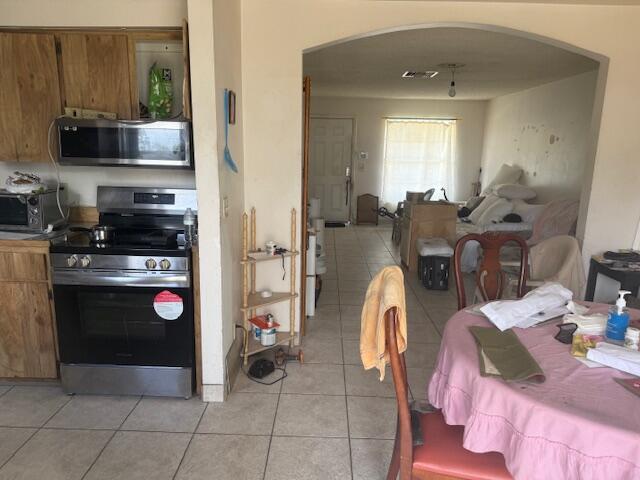 448 Perry Avenue Greenacres, FL 33463 - Photo 5 of 14 a kitchen with stainless steel appliances a stove a sink and a refrigerator