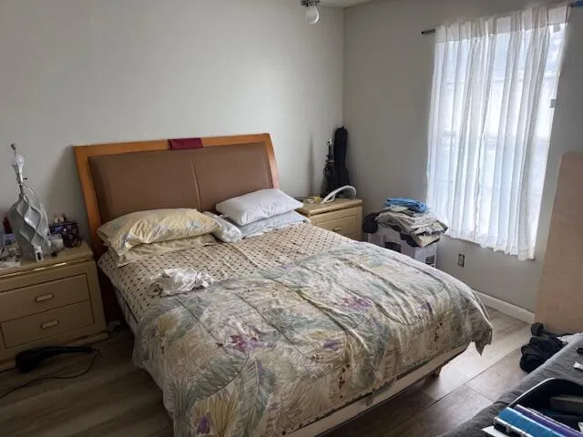 a bedroom with a bed and window