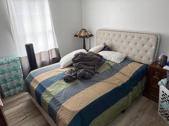 448 Perry Avenue Greenacres, FL 33463 - Photo 9 of 14 a bed sitting in a bedroom next to a window