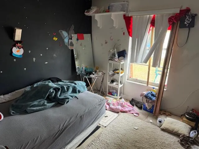 a bedroom with bed and a window