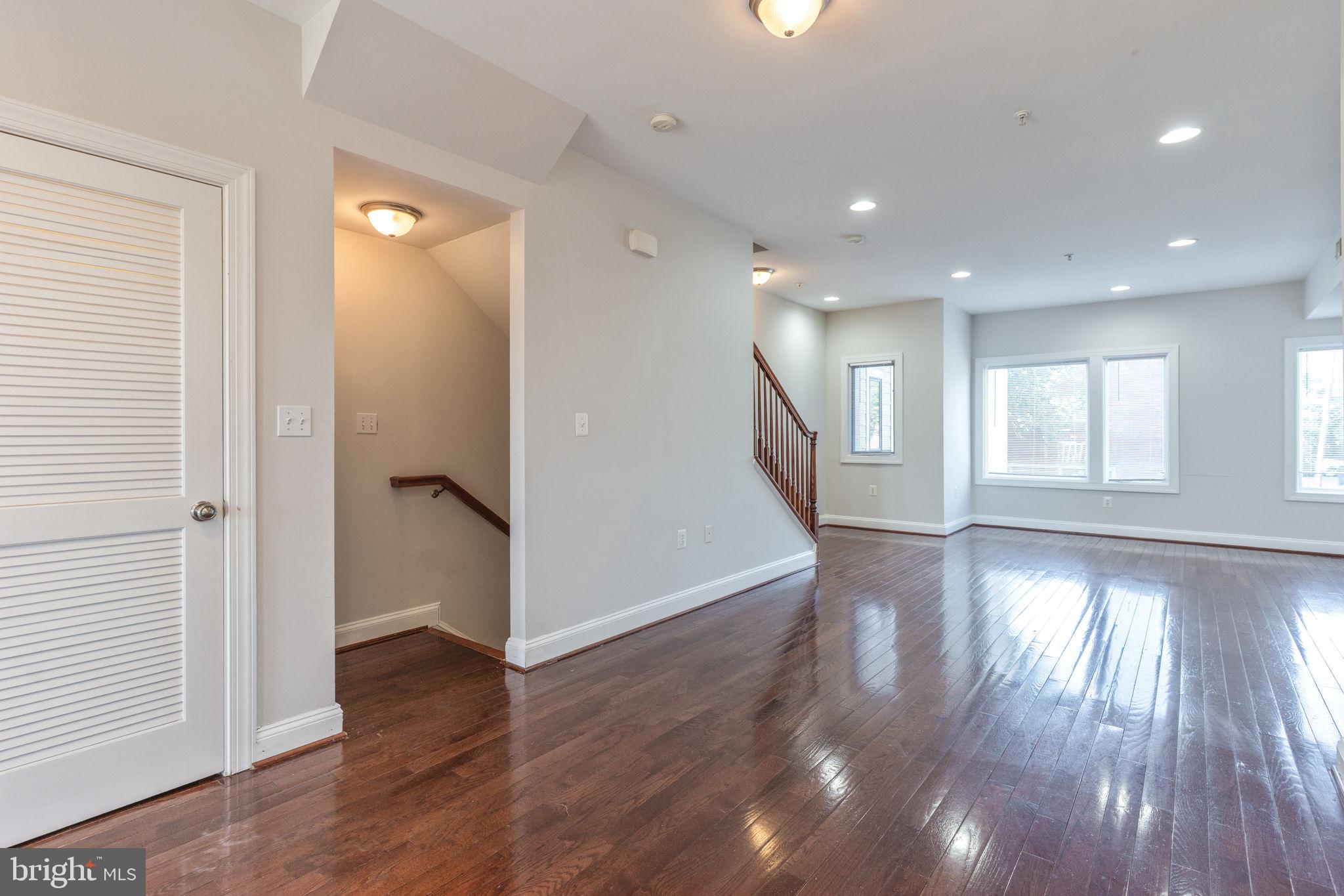 1384 Talbert Court Southeast, Unit A Washington, DC 20020 - Photo 11 of 35 a view of an empty room with wooden floor and a window