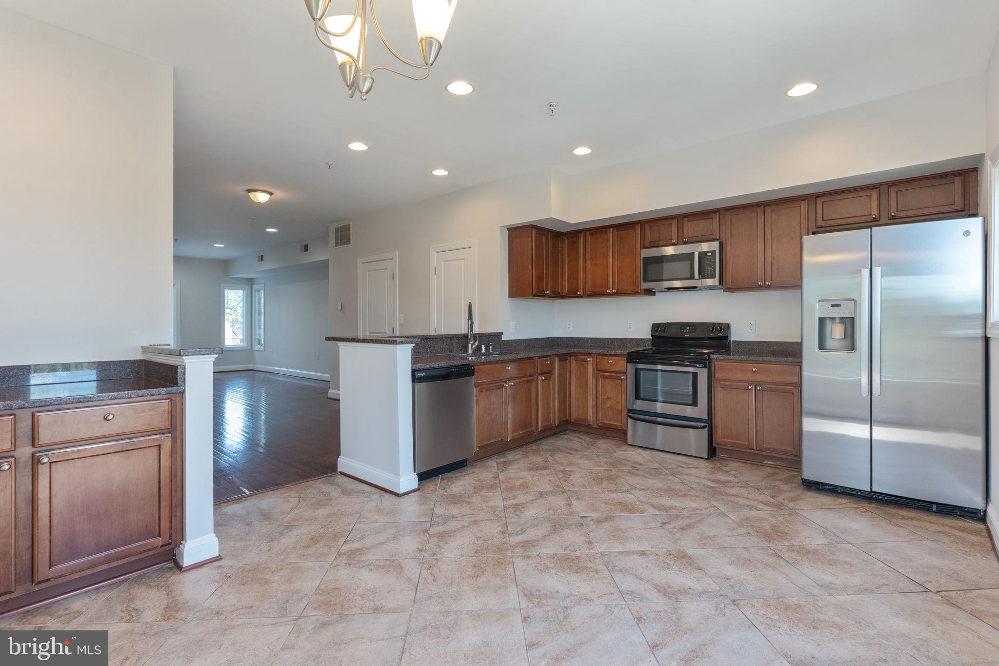 1384 Talbert Court Southeast, Unit A Washington, DC 20020 - Photo 14 of 35 a kitchen with stainless steel appliances granite countertop a refrigerator and a stove