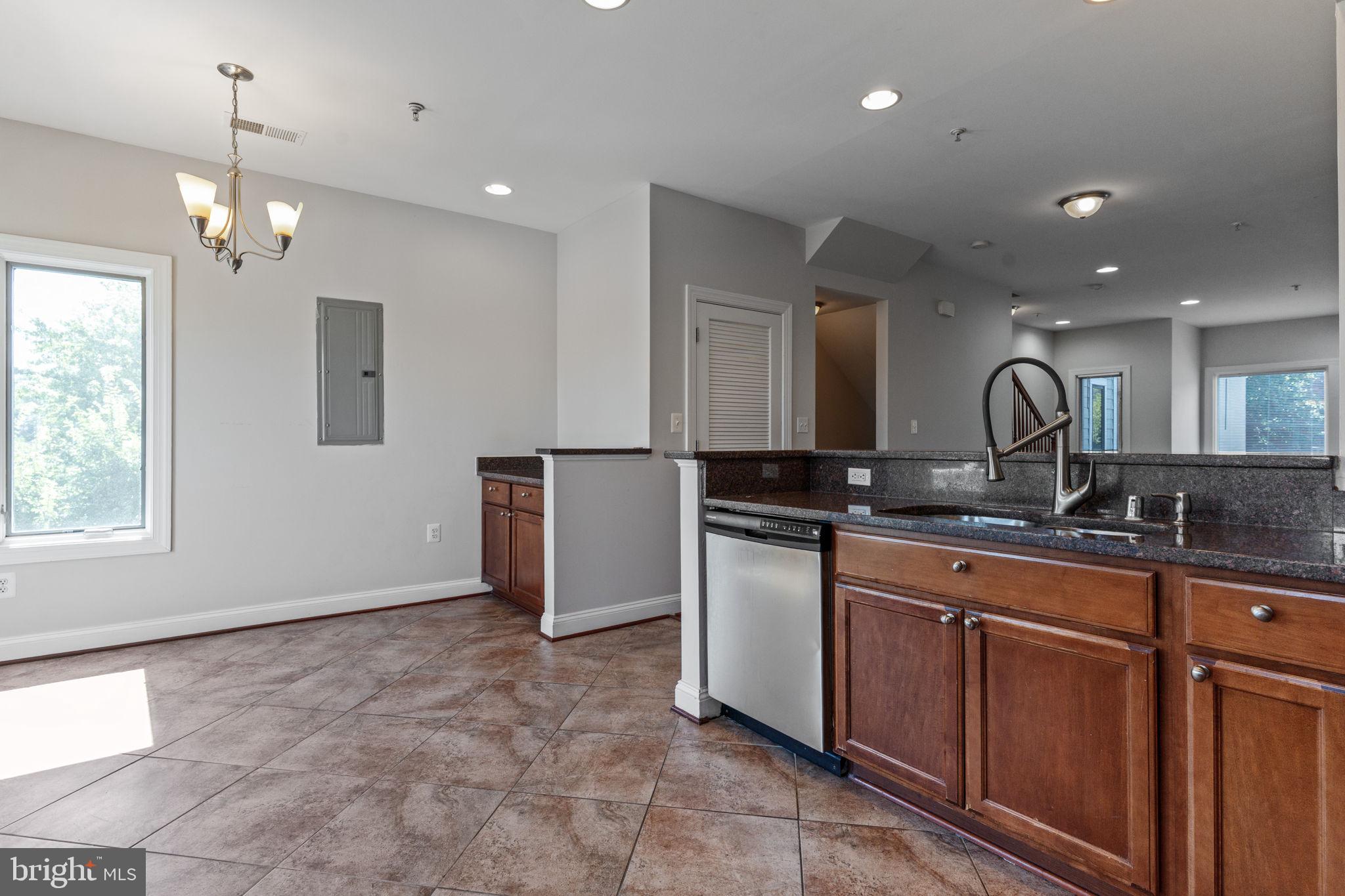 1384 Talbert Court Southeast, Unit A Washington, DC 20020 - Photo 19 of 35 a large kitchen with kitchen island a sink stainless steel appliances and a counter top space