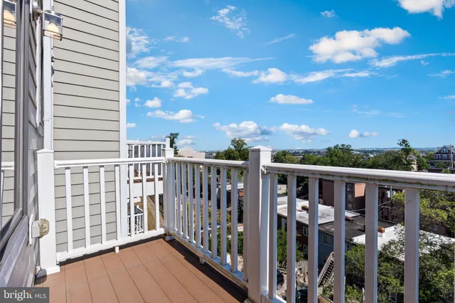 a view of a balcony with wooden floor