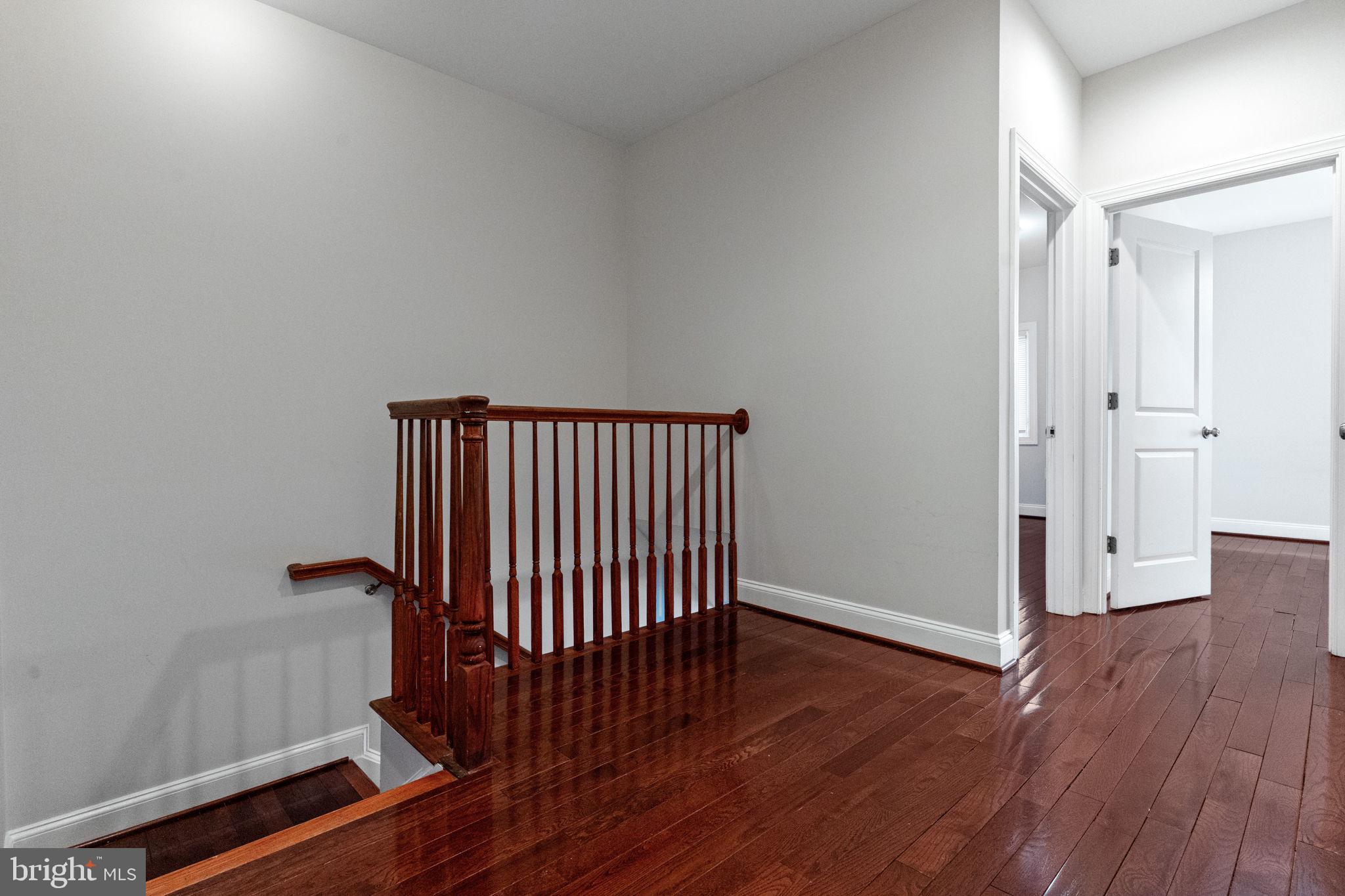 1384 Talbert Court Southeast, Unit A Washington, DC 20020 - Photo 29 of 35 a view of a hallway with wooden floor and a bathroom